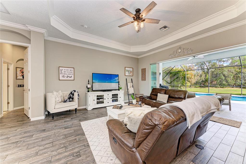 16336 26th Street East Parrish, FL 34219 - Photo 16 of 69 a living room with furniture fireplace and a large window