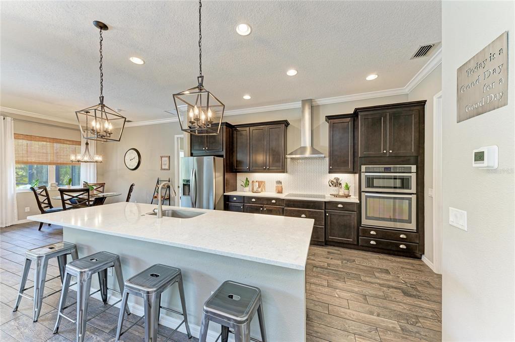 16336 26th Street East Parrish, FL 34219 - Photo 20 of 69 a kitchen with counter space cabinets and stainless steel appliances