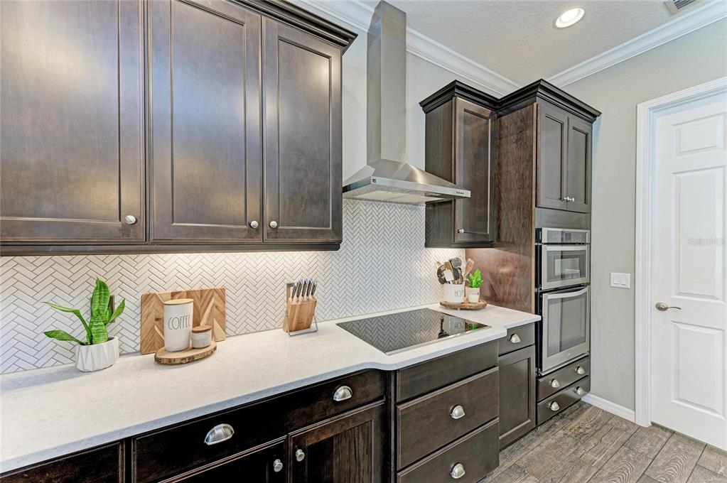 16336 26th Street East Parrish, FL 34219 - Photo 24 of 69 a kitchen with stainless steel appliances a sink stove and cabinets