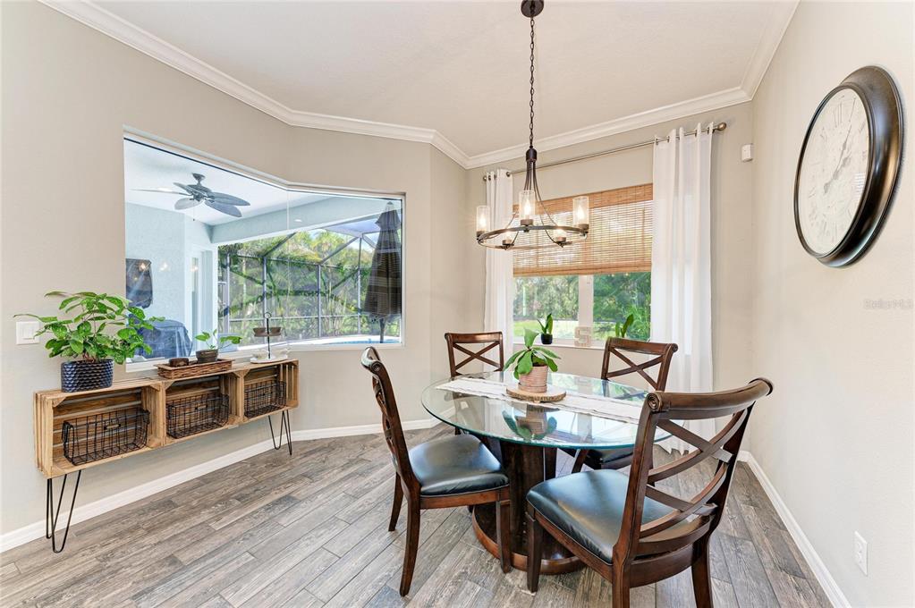 16336 26th Street East Parrish, FL 34219 - Photo 28 of 69 a view of a dining room with furniture window and wooden floor