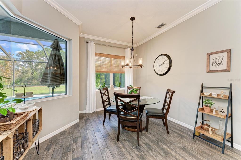 16336 26th Street East Parrish, FL 34219 - Photo 29 of 69 a view of a dining room with furniture window and wooden floor