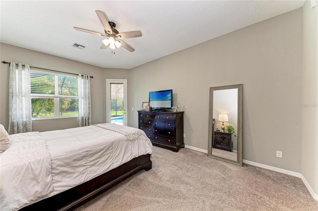 16336 26th Street East Parrish, FL 34219 - Photo 30 of 69 a bedroom with a large bed and a window