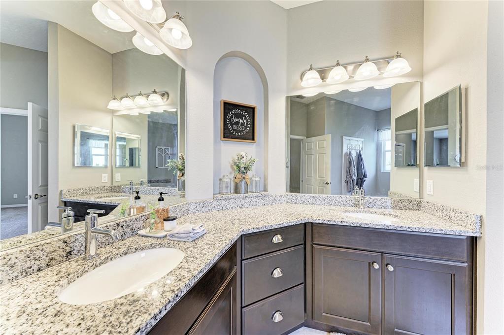 16336 26th Street East Parrish, FL 34219 - Photo 34 of 69 a bathroom with a granite countertop double vanity sink and a mirror