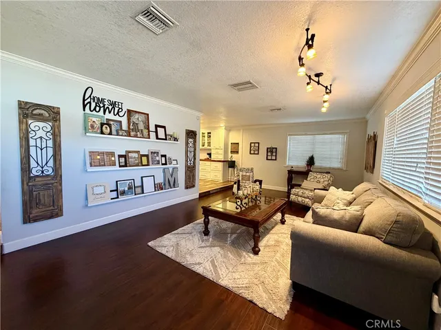 a view of a patio with table and chairs potted plants and large tree