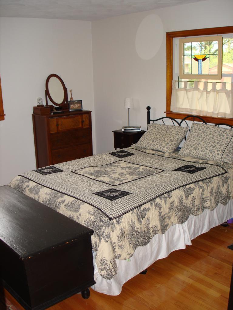 231 Poplar Drive Blue Ridge, VA 24064 - Photo 6 of 6 a bedroom with a bed and dresser with mirror