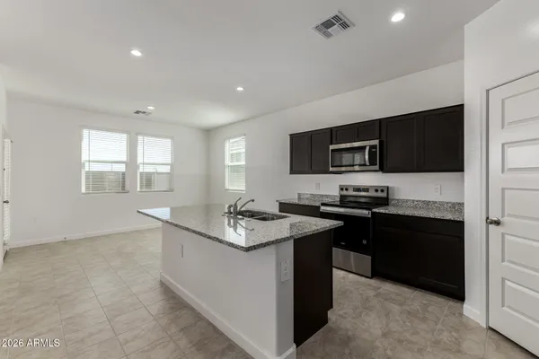 a kitchen with a sink stove and microwave