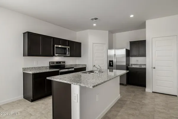 a kitchen with a sink stove and refrigerator