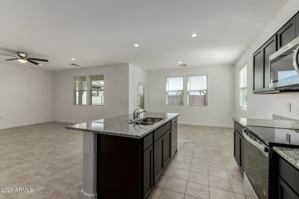 a kitchen with a sink window and cabinets