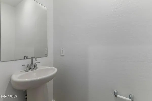 a bathroom with a sink a mirror and a toilet