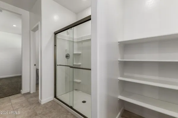 a bathroom with a glass shower door