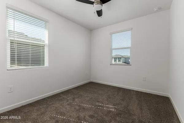 a view of room with a ceiling fan and window