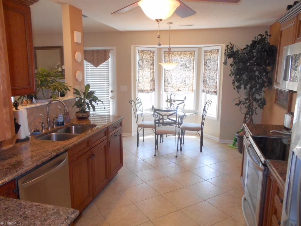 4301 Shade Tree Court High Point, NC 27265 - Photo 11 of 23 Large eat-in kitchen with lots of natural light and a ceiling fan