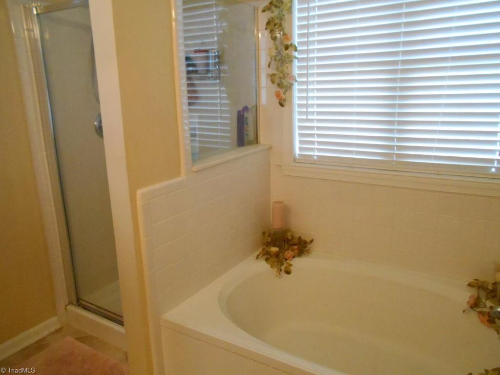 4301 Shade Tree Court High Point, NC 27265 - Photo 15 of 23 A spa like tub and walk-in shower in the master bath