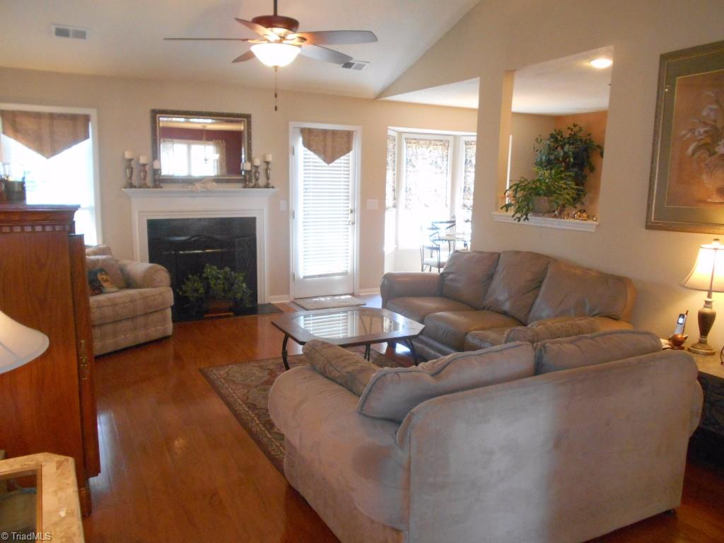4301 Shade Tree Court High Point, NC 27265 - Photo 5 of 23 Living room has gas logs and a ceiling fan with 13 Ft. ceilings at the peak