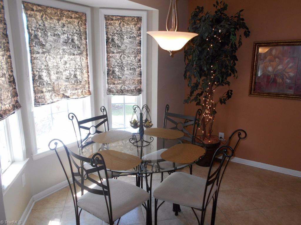 4301 Shade Tree Court High Point, NC 27265 - Photo 7 of 23 Breakfast area sits in a bay window looking over the backyard and patio