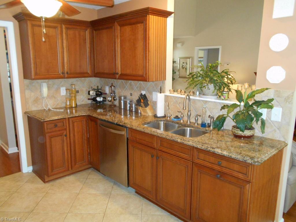 4301 Shade Tree Court High Point, NC 27265 - Photo 8 of 23 Updated kitchen has all stainless steel appliances and tile back splash throughout