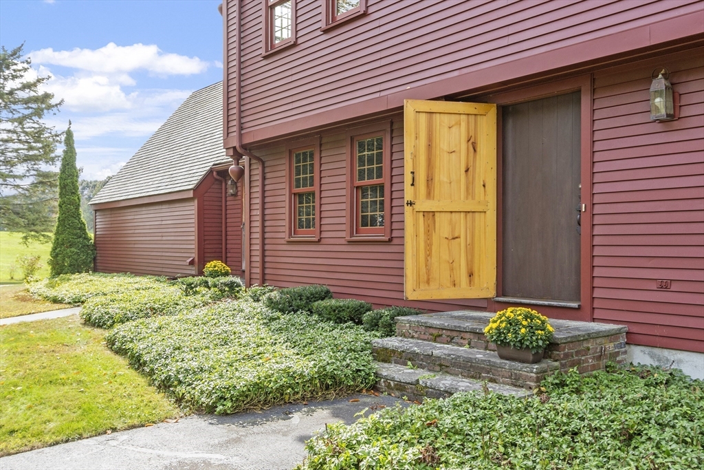 286 Old Bay Road Bolton, MA 01740 - Photo 3 of 37 a front view of a house with garden