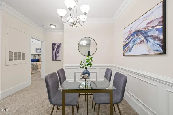 a dining room with furniture and chandelier
