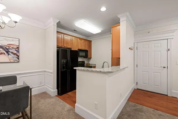 a kitchen with a refrigerator and a stove top oven