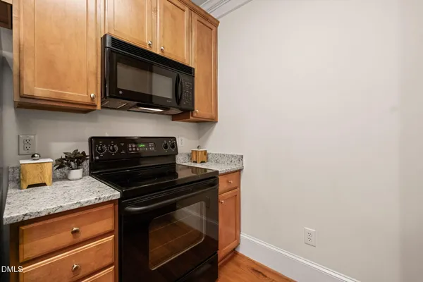 a kitchen with stainless steel appliances wooden cabinets and a stove top oven