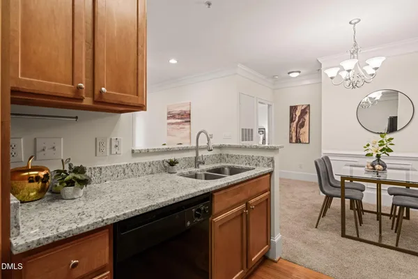 a kitchen with stainless steel appliances granite countertop a sink a stove and a wooden floors