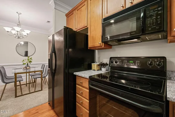 a kitchen with stainless steel appliances granite countertop a stove and a microwave