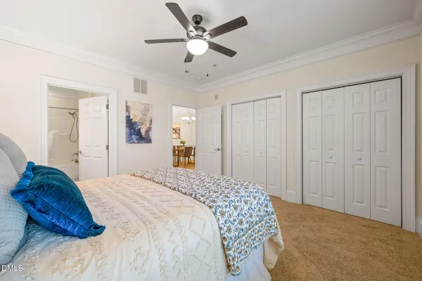 a spacious bedroom with a bed and a ceiling fan