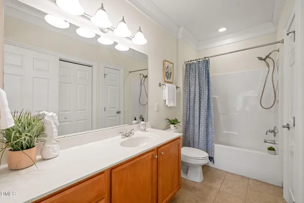 a bathroom with a granite countertop sink a toilet and shower