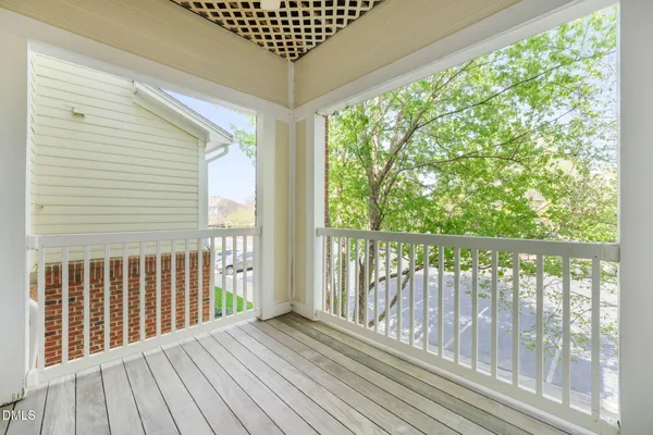 a view of balcony with wooden floor