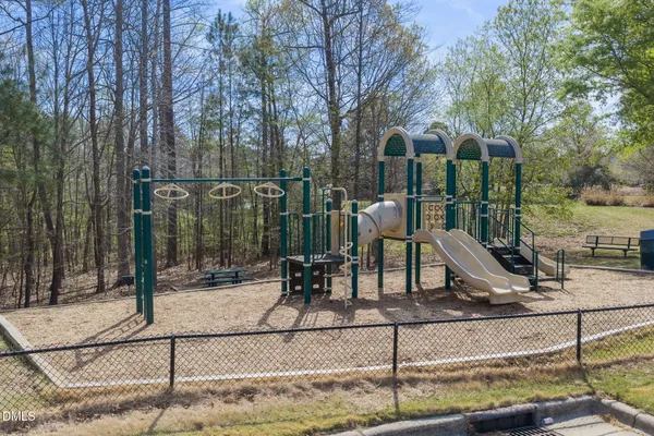 a view of a park with iron fence
