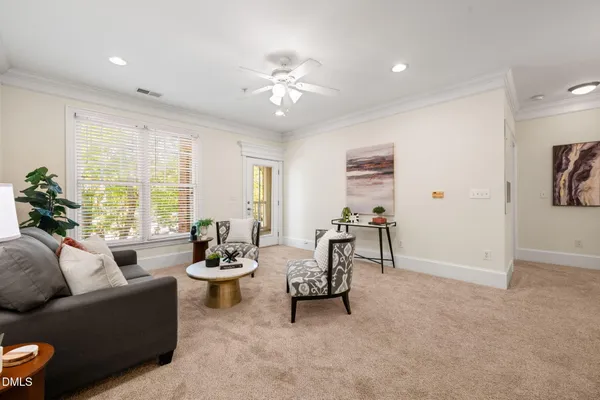 a living room with furniture and white walls