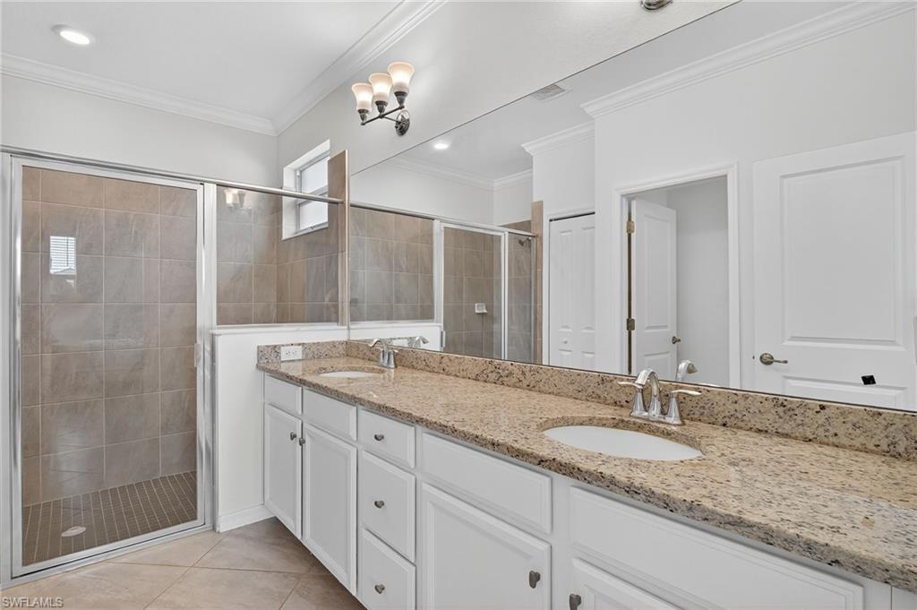 2126 Hamlin Street Naples, FL 34120 - Photo 12 of 34 a bathroom with a granite countertop sink and a mirror