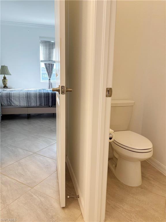 2126 Hamlin Street Naples, FL 34120 - Photo 13 of 34 a bathroom with a toilet a sink and a window