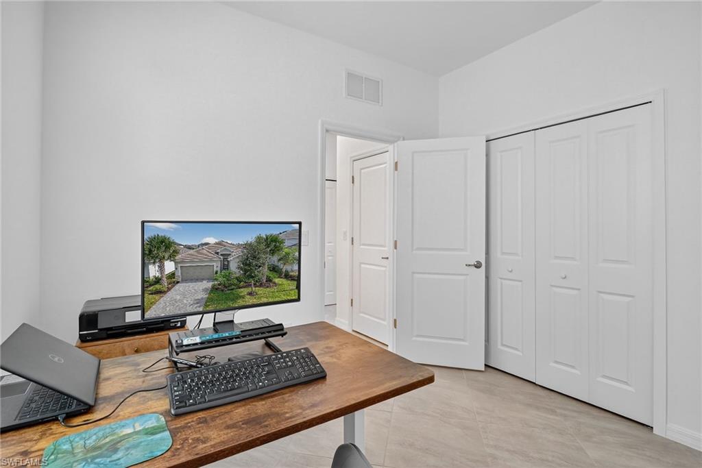 2126 Hamlin Street Naples, FL 34120 - Photo 18 of 34 a living room with furniture and a flat screen tv