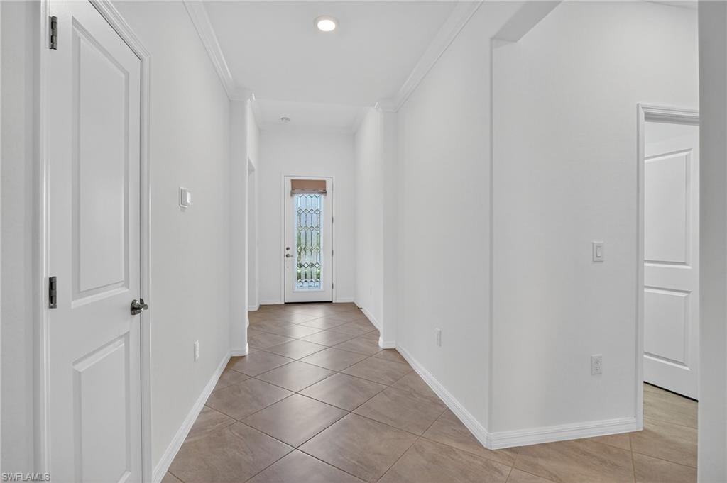 2126 Hamlin Street Naples, FL 34120 - Photo 2 of 34 a view of a hallway with a wooden space