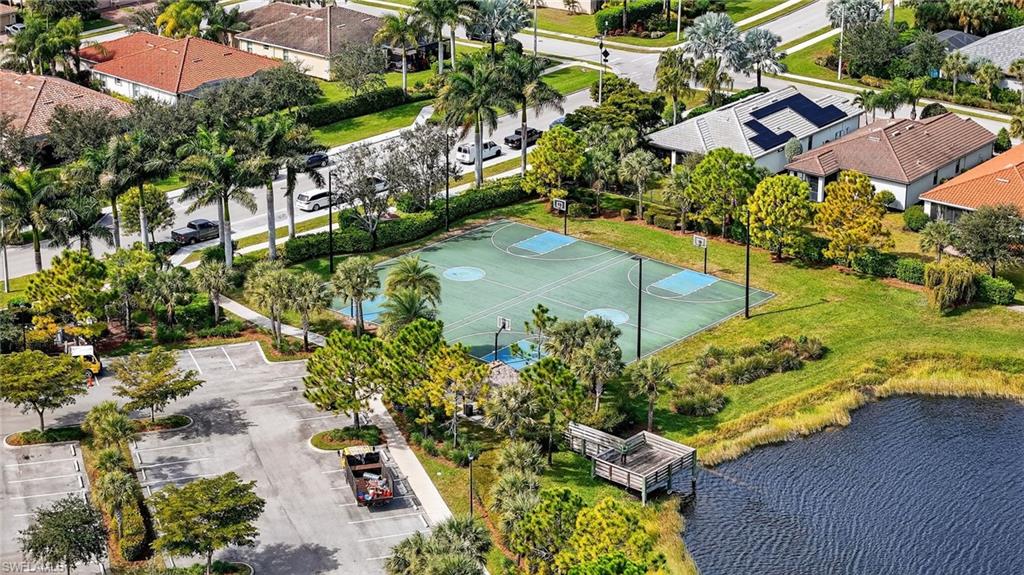 2126 Hamlin Street Naples, FL 34120 - Photo 29 of 34 an aerial view of a house with a yard and lake view