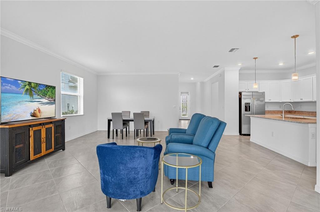 2126 Hamlin Street Naples, FL 34120 - Photo 6 of 34 a living room with furniture and a kitchen