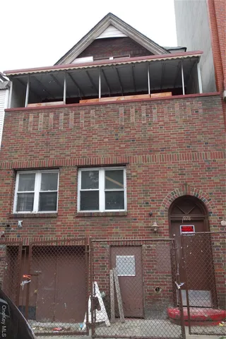 a front view of a house with plants