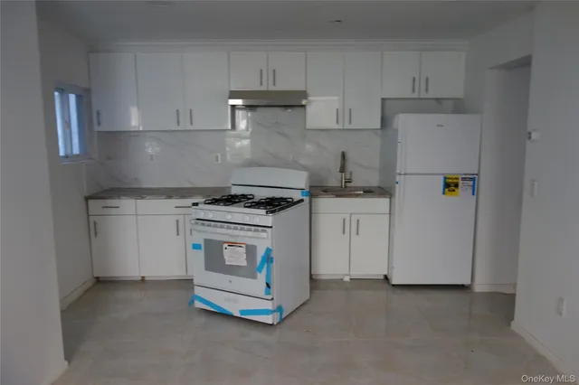 a kitchen with a stove and a refrigerator
