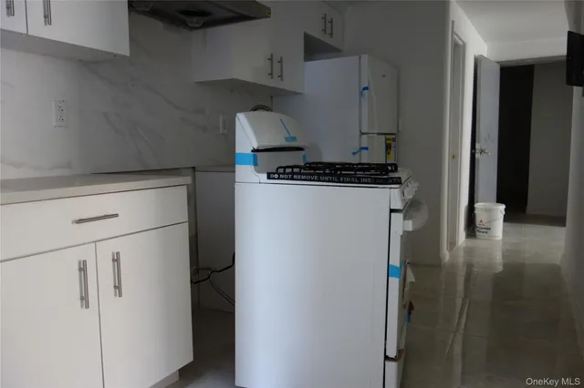 a kitchen with a refrigerator and a stove