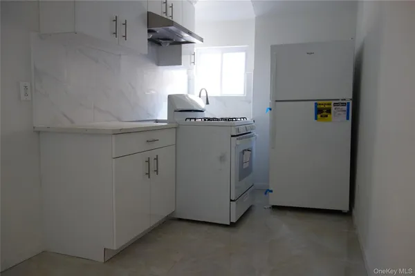 a utility room with cabinets washer and dryer