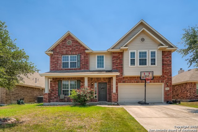 a front view of house with yard and green space