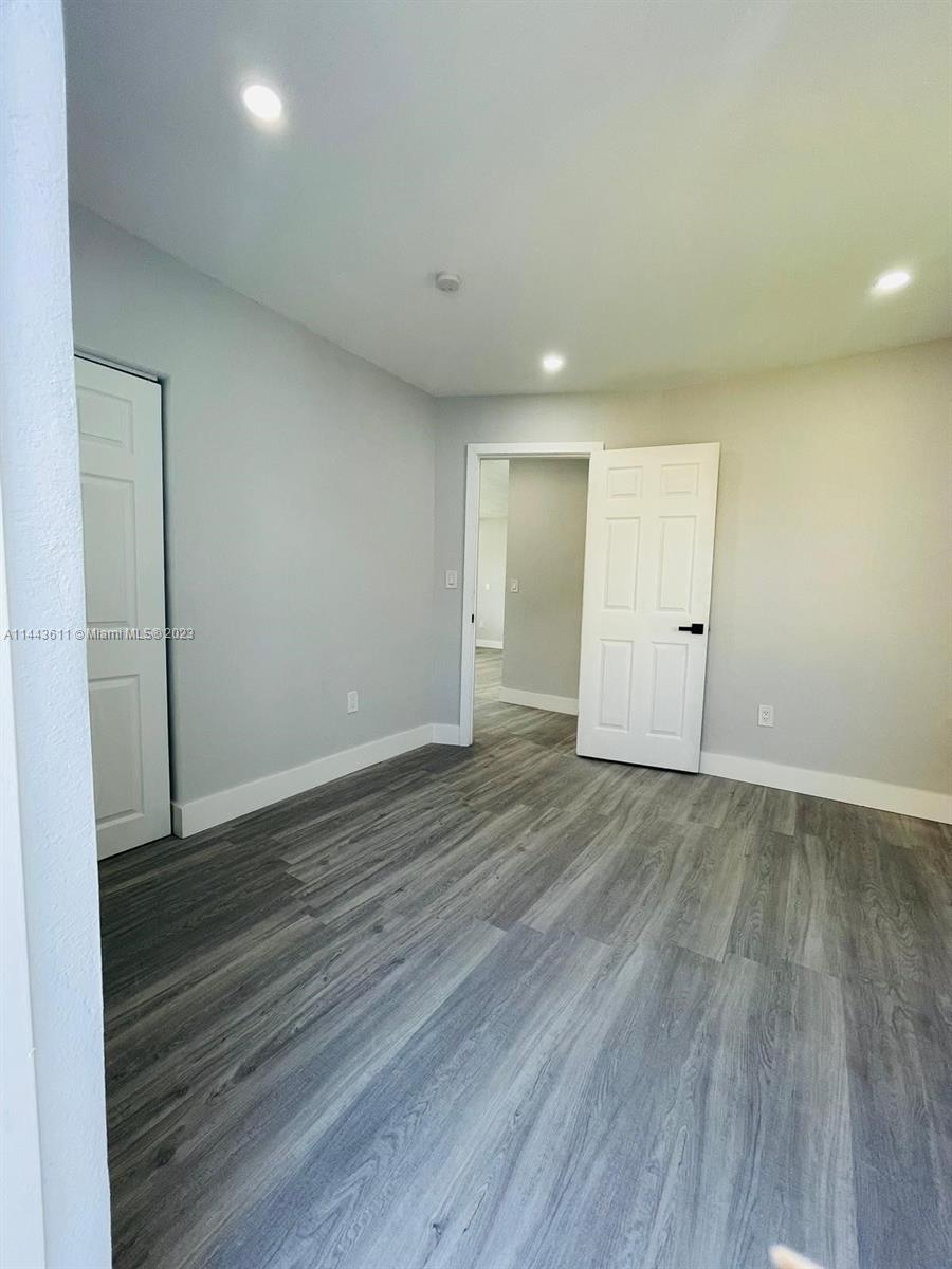 2521 Northwest 121st Street Miami, FL 33167 - Photo 11 of 43 a view of an empty room with wooden floor