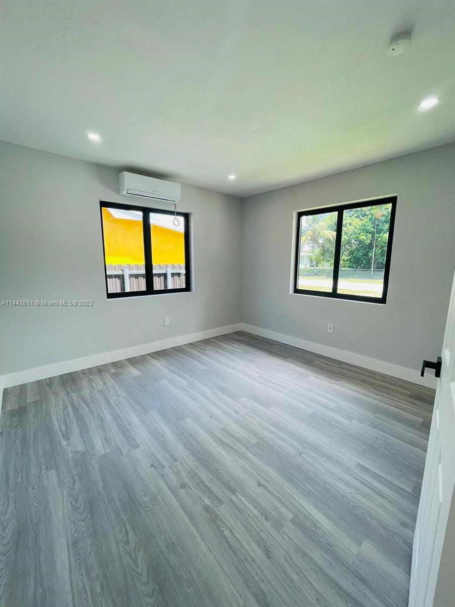 2521 Northwest 121st Street Miami, FL 33167 - Photo 12 of 43 a view of empty room with windows