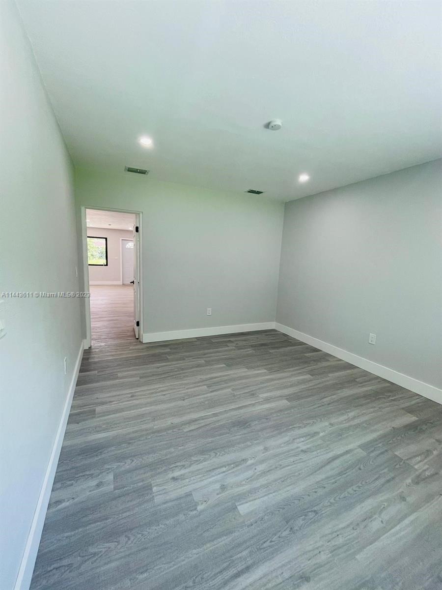 2521 Northwest 121st Street Miami, FL 33167 - Photo 13 of 43 a view of room with wooden floor