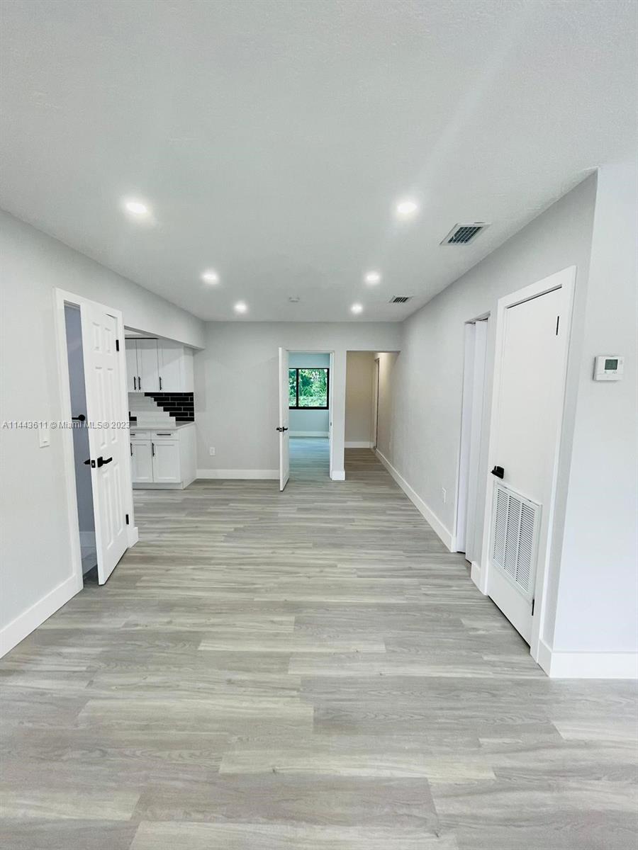 2521 Northwest 121st Street Miami, FL 33167 - Photo 16 of 43 a view of a living room a refrigerator and a window