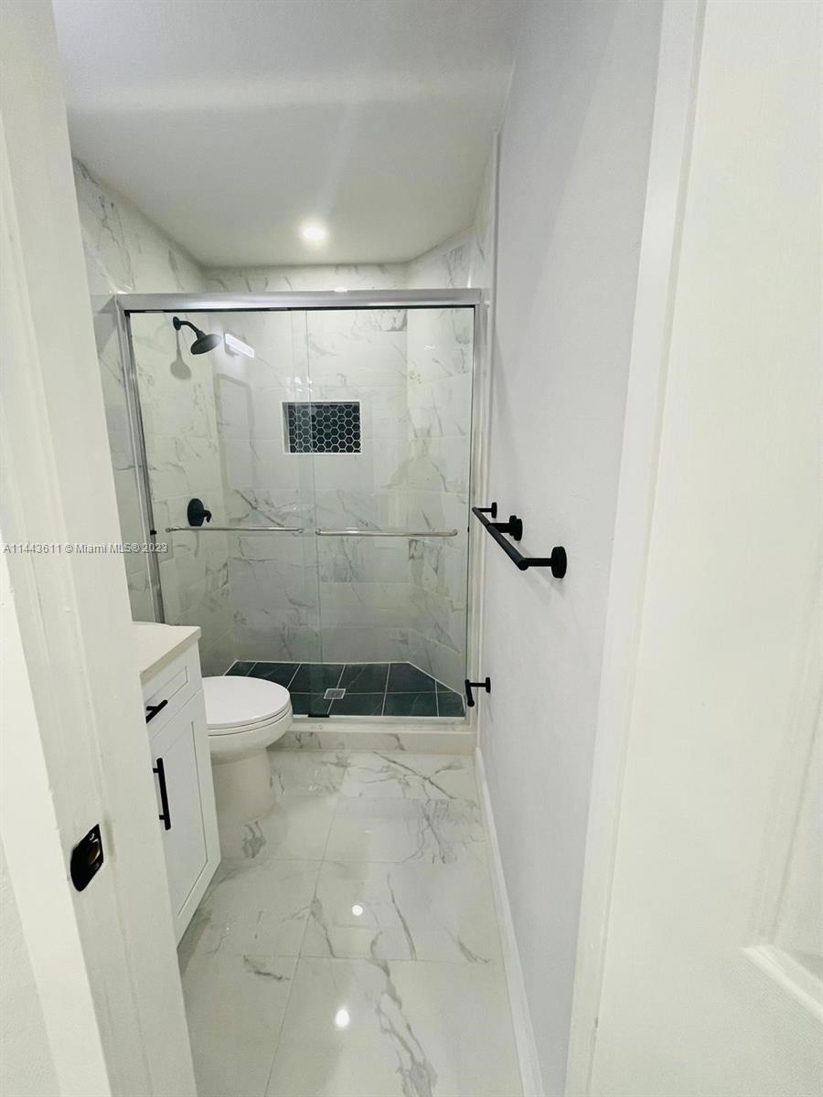 2521 Northwest 121st Street Miami, FL 33167 - Photo 18 of 43 a bathroom with a shower and toilet