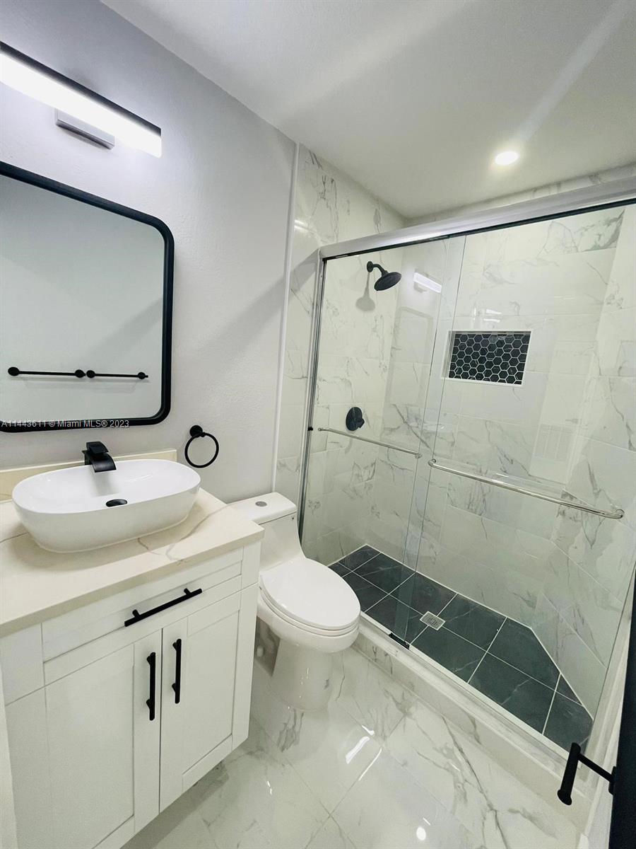 2521 Northwest 121st Street Miami, FL 33167 - Photo 19 of 43 a bathroom with a sink toilet and shower