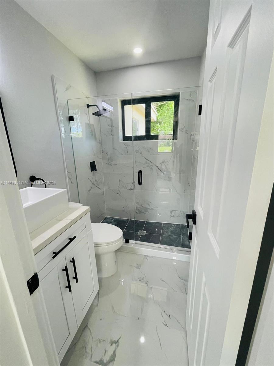 2521 Northwest 121st Street Miami, FL 33167 - Photo 20 of 43 a bathroom with a sink a toilet and mirror