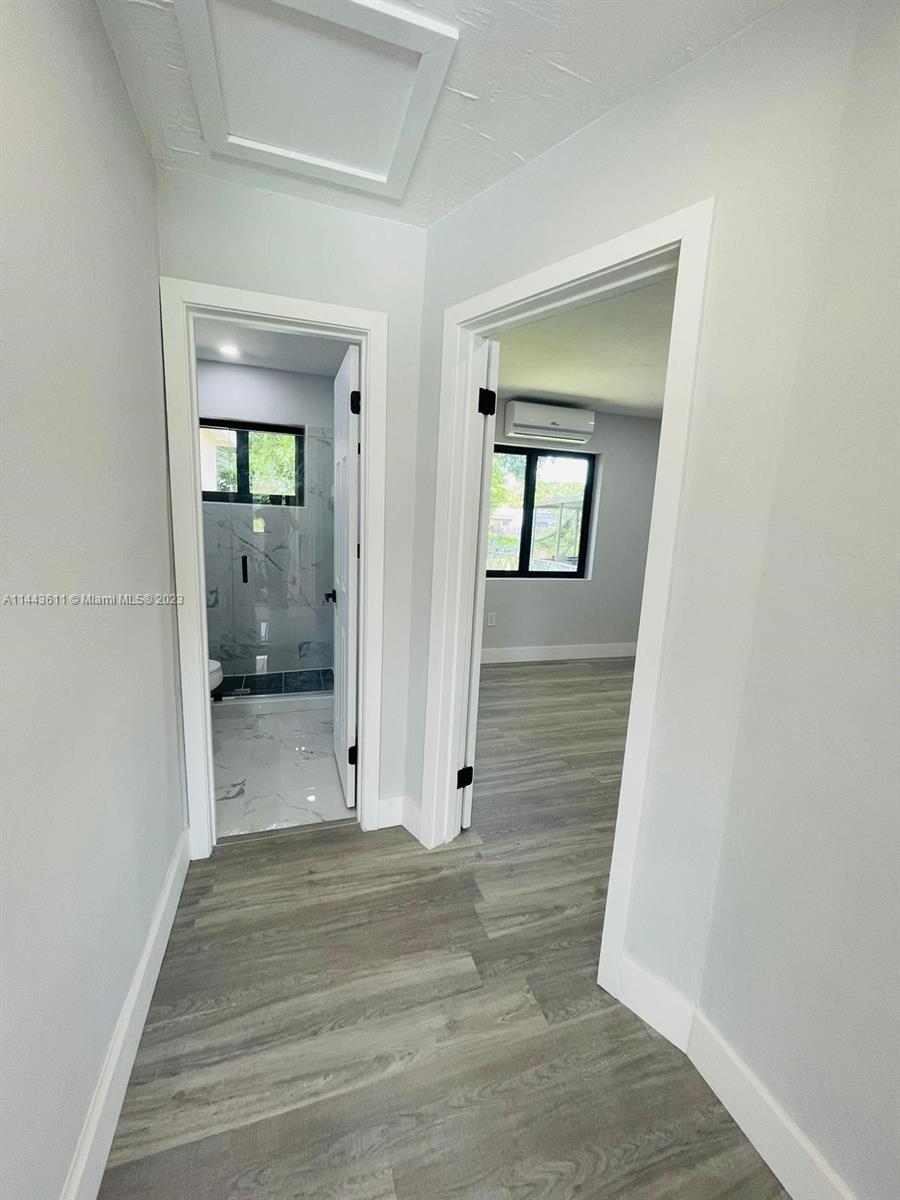 2521 Northwest 121st Street Miami, FL 33167 - Photo 21 of 43 a view of a hallway with wooden floor and closet